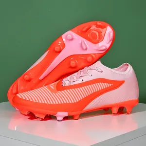 Professional pink and orange flyknit soccer cleats for firm ground and artificial turf.