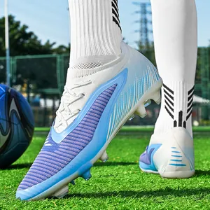 Seamless flyknit soccer cleats in blue and white gradient for training on artificial grass