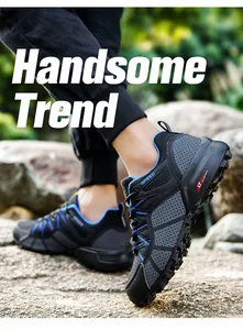 Detailed view of men's breathable hiking shoes with anti-slip soles on outdoor rocky terrain