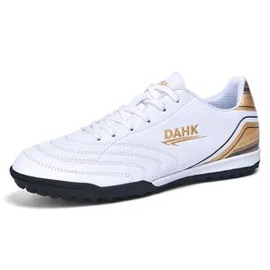 White and gold TF turf soccer shoes for training and competition for students