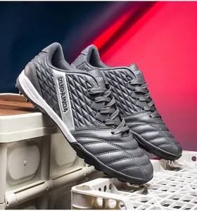 Detailed close-up of grey outdoor turf soccer shoes featuring textured synthetic upper