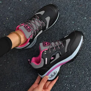 Close-up of women's black and pink hiking shoes with breathable mesh and air cushion