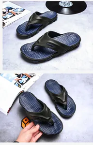 Detailed macro view of stylish men's beach flip-flops with blue massage textured footbed