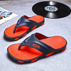 Stylish men's summer flip-flops with navy blue straps and orange footbed for beach