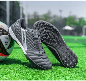 Close-up of grey turf soccer shoes showing textured upper and grippy rubber sole