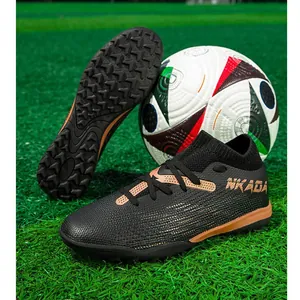 Professional knitted soccer shoes with turf cleats for training in black and gold finish