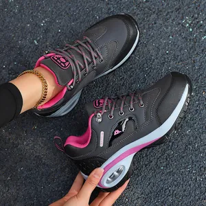 Close-up of grey and pink women's hiking shoes with thick air cushion soles