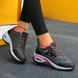Side view of stylish women's grey platform hiking sneakers featuring pink air cushions.