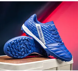 Close-up of blue soccer shoes with textured upper and turf cleats for outdoor training.