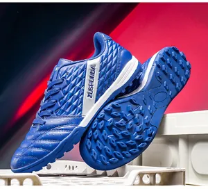 Close-up of blue turf soccer shoes showing sole grip and textured upper