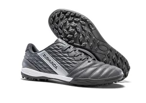 Detailed view of grey TF soccer shoes with non-slip turf studs for outdoor training