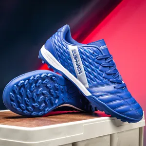 Blue outdoor turf soccer shoes for grass training with textured upper and rubber sole