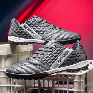 Professional dark gray turf soccer shoes for outdoor grass training with ZUSHUNDA branding