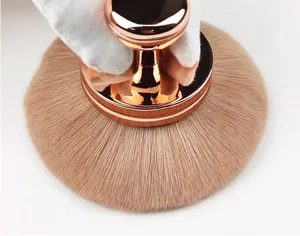 Detailed view of a large mushroom-head makeup brush with soft bristles and rose gold handle.