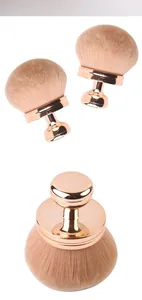 Close-up detail of a mushroom-head makeup brush with soft bristles and rose gold base