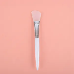 Professional pink silicone face mask brush with white handle for skincare application