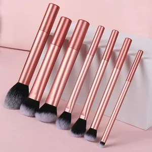 Macrodetail van roségouden make-up borstelset met zachte grijze synthetische haren