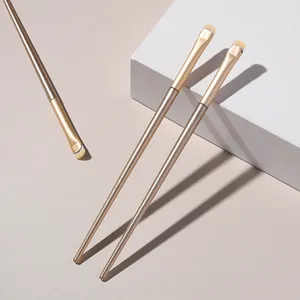 Close-up detail of small crescent-shaped eyeshadow brushes for aegyo-sal and eyeliner makeup