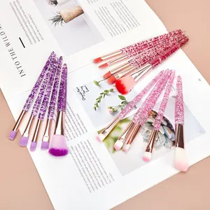 Detailweergave van een set kleurrijke make-upborstels met glitterzand kristallen handvatten