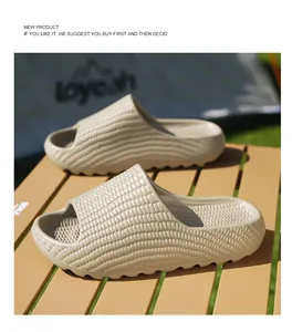 Beige unisex thick-soled slides featuring unique corn texture on an outdoor camping table