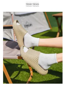 Outdoor khaki textured thick-sole slides with corn pattern design worn on outdoor chair