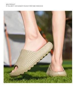 Detailed macro view of khaki woven texture slides for beachwear worn on green grass