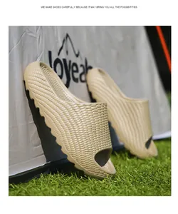 Detailed view of beige slides with braided corn texture and thick rippled soles on grass