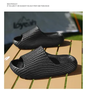 Black textured slides with thick non-slip soles on an outdoor camping table