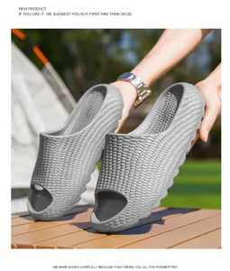 Detailed view of grey textured thick-sole slide sandals in an outdoor camping setting.