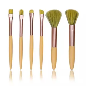 Detailed view of 6-piece mini makeup brush set with green bristles and wooden handles