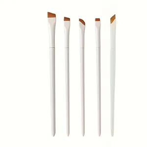 Detailed view of 5-piece makeup brush set with white handles and angled bristles