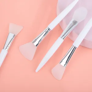 Detailed view of soft silicone facial mask brushes with white handles for mud application