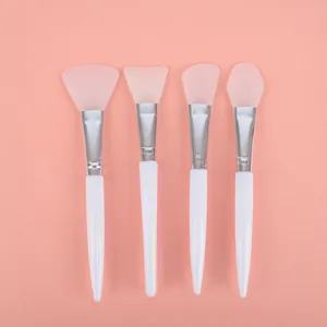 Set of four PRT silicone facial mask brushes with white handles and various head shapes