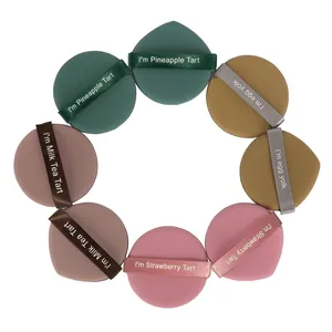 Set of colorful makeup puffs arranged in a circle, featuring food-themed ribbons.