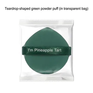 Pointed green makeup puff in transparent packaging, pineapple tart style blender