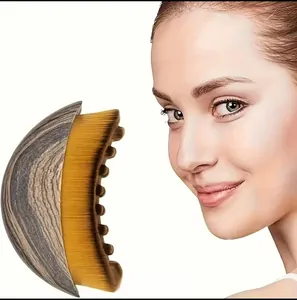 Detailed view of a lymphatic contour massage brush with soft golden yellow bristles