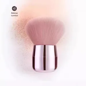 Close-up of pink mushroom head makeup brush with soft bristles and powder splash