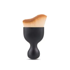 Close-up of black curved makeup brush with wavy dual-tone bristles for contouring.