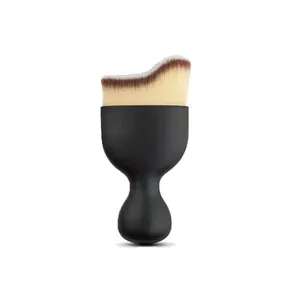 Detail view of a curved wave makeup brush with black ergonomic handle on white background