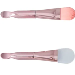 Rose gold dual-ended makeup brush set featuring pink soft bristles and silicone head with scoop
