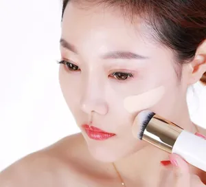 Detailed macro shot of a chubby foundation brush applying smooth makeup on face