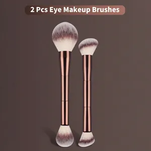Detailed view of professional double-ended eye makeup brushes in rose gold finish