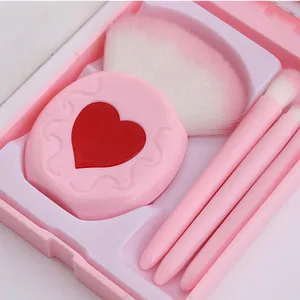 Close-up of pink heart-shaped makeup brush and bristles in matching storage case