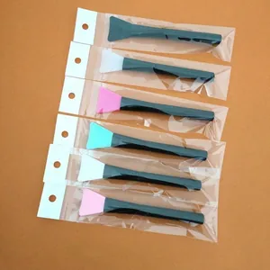 Silicone facial mask brushes with black handles, individually packed in transparent bags