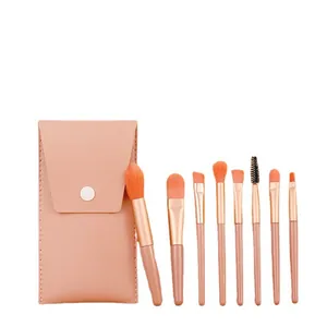 Professional 8-piece mini makeup brush set with orange soft bristles and pink storage pouch