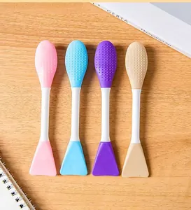 Macro view of double-ended silicone facial mask brushes in multiple pastel colors