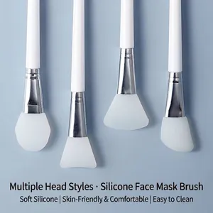 Professional silicone face mask brush set with long handles for facial mud mask application.