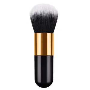 Portable chubby makeup brush for blush and powder, featuring a black and gold handle.
