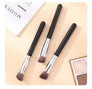 Detail view of three slanted triangle makeup brushes for contouring and concealer.