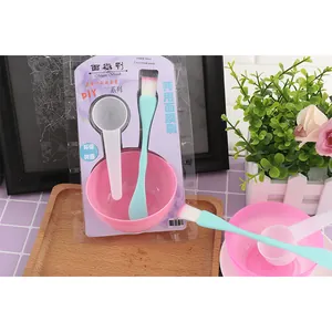 Close-up detail of 3-in-1 facial mask DIY tool set with pink bowl and green brush